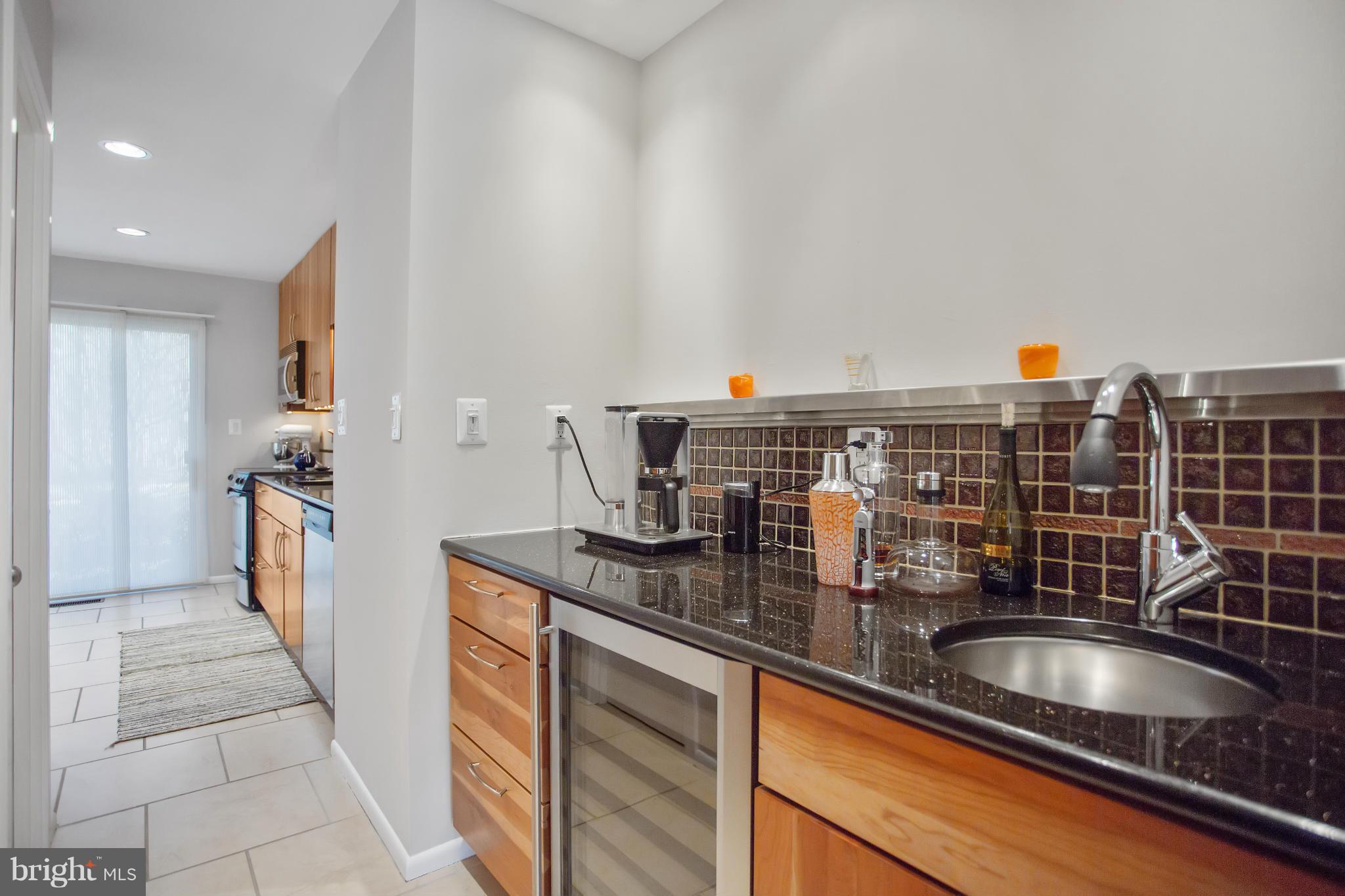 2040 Lakebreeze Way Reston, VA 20191 - Photo 8 of 29 a kitchen with a sink and a refrigerator