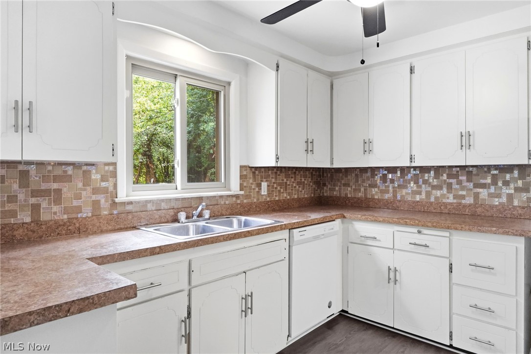 2537 Edgewood Road Beachwood, OH 44122 - Photo 14 of 39 Kitchen featuring extensive white cabinetry with brushed nickel hardware, a double basin stainless steel sink, and a multi-tone mosaic tile backsplash