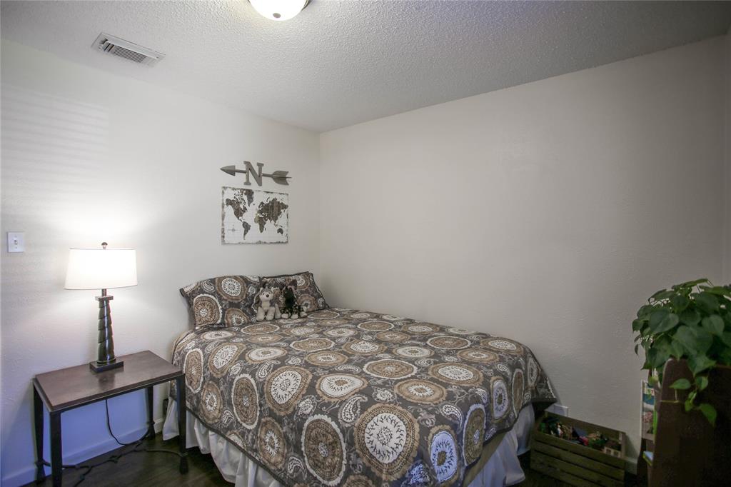 1720 Crystal Way Plano, TX 75074 - Photo 20 of 32 a bedroom with a bed and a potted plant