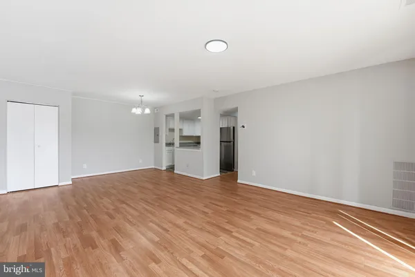 a view of empty room with wooden floor