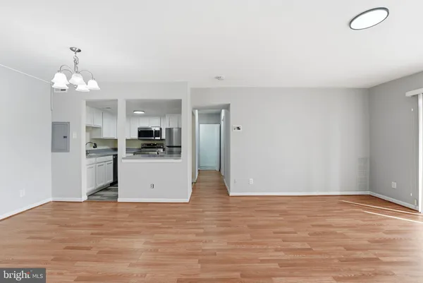 a view of a kitchen with cabinets and wooden floor