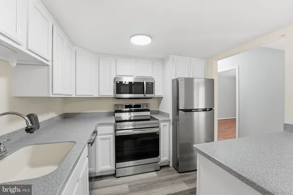 a kitchen with a refrigerator sink and microwave