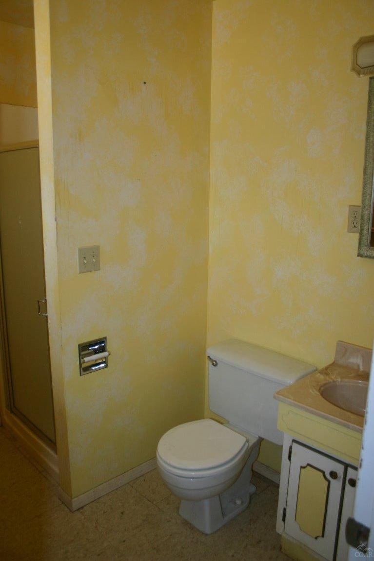 19129 Pumice Butte Road Bend, OR 97702 - Photo 14 of 18 a white toilet sitting next to a shower