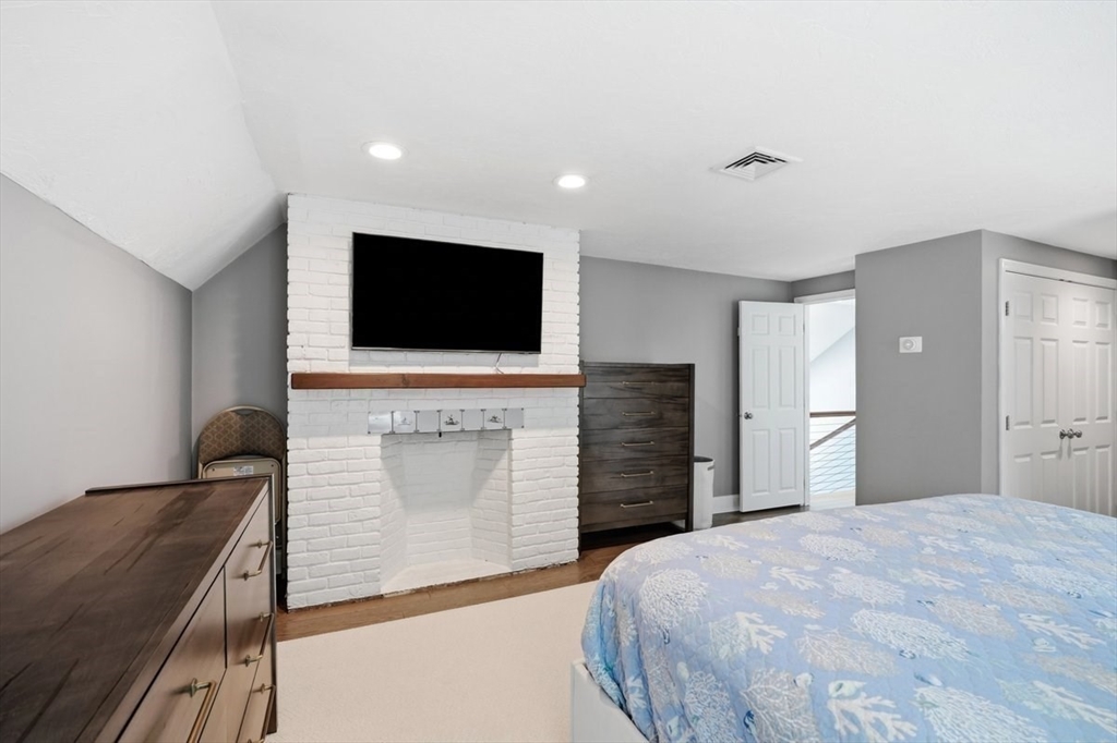 47 Old Coach Road Cohasset, MA 02025 - Photo 21 of 40 a bedroom with a bed and a flat screen tv