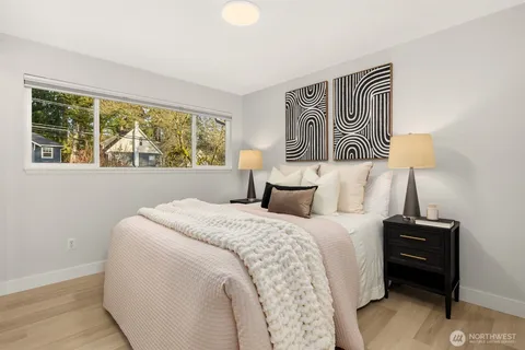 a bedroom with a bed and a night stand