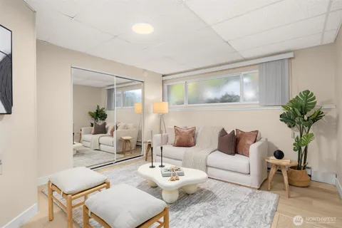 a living room with furniture and a potted plant