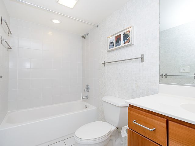 1151 West 15th Street, Unit 209 Chicago, IL 60608 - Photo 14 of 30 a bathroom with a sink a toilet and a bathtub