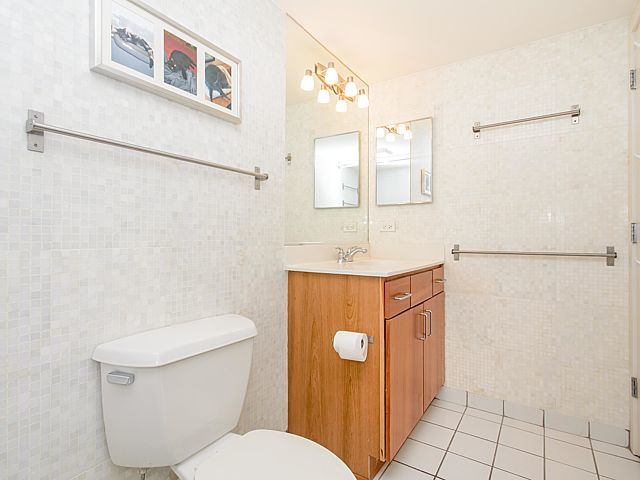 1151 West 15th Street, Unit 209 Chicago, IL 60608 - Photo 15 of 30 a bathroom with a toilet sink and mirror