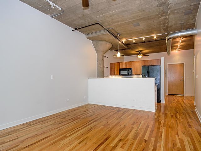 1151 West 15th Street, Unit 209 Chicago, IL 60608 - Photo 7 of 30 a view of a kitchen with wooden floor