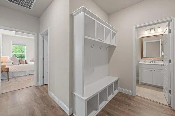 a bedroom with a bed a couch and a chandelier