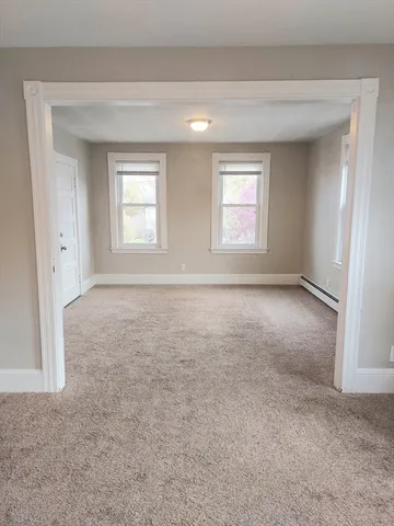 an empty room with windows and closet