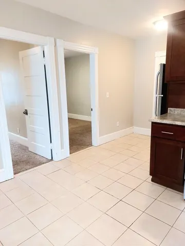 a view of a kitchen cabinets and empty room