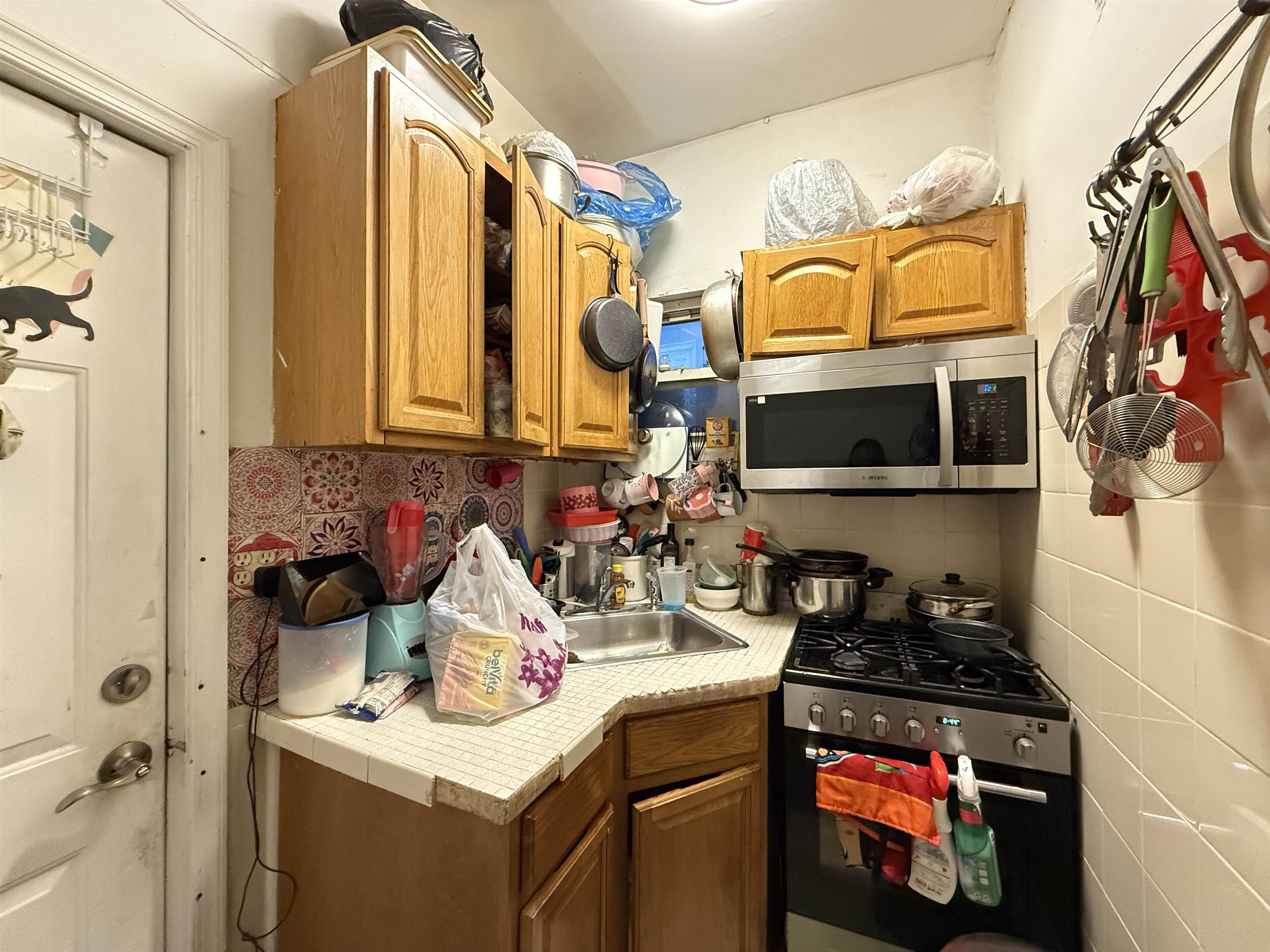 1309 Summit Avenue Union City, NJ 07087 - Photo 25 of 31 a kitchen with a stove and a sink
