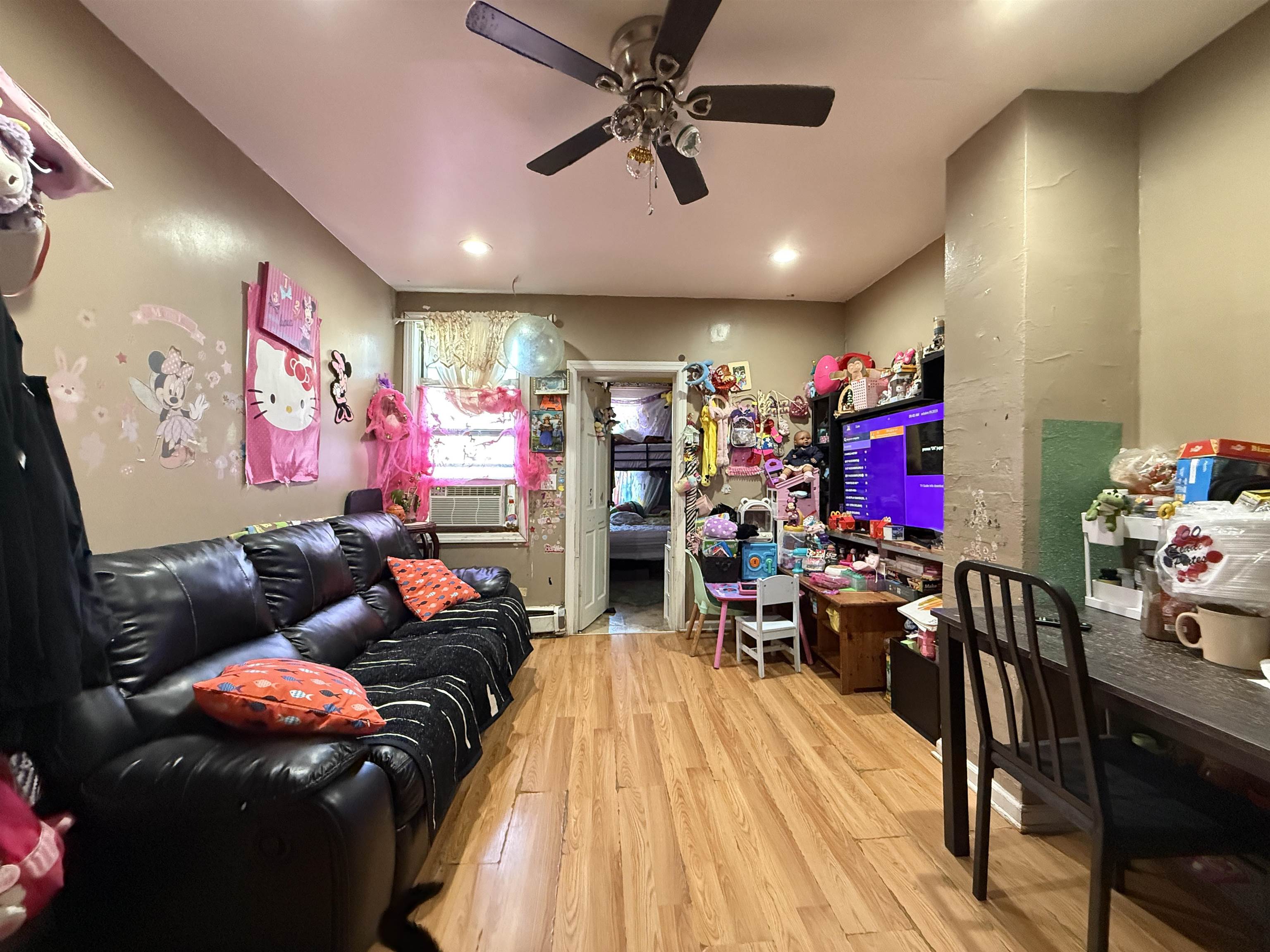 1309 Summit Avenue Union City, NJ 07087 - Photo 28 of 31 a living room filled with furniture and a flat screen tv