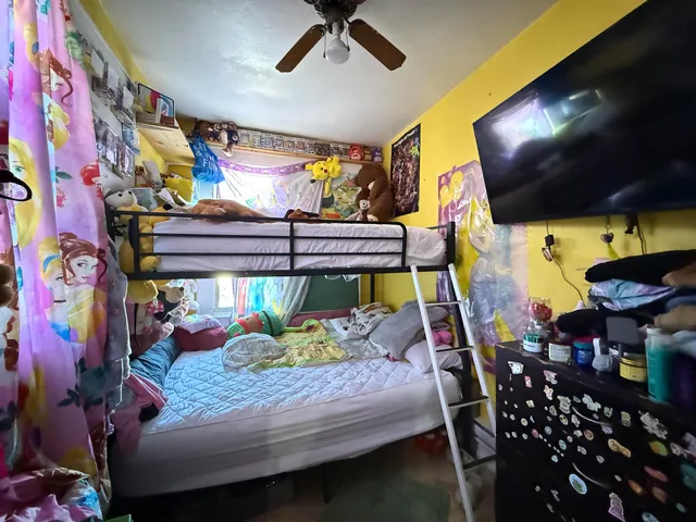 a bed room with a bed and a tv