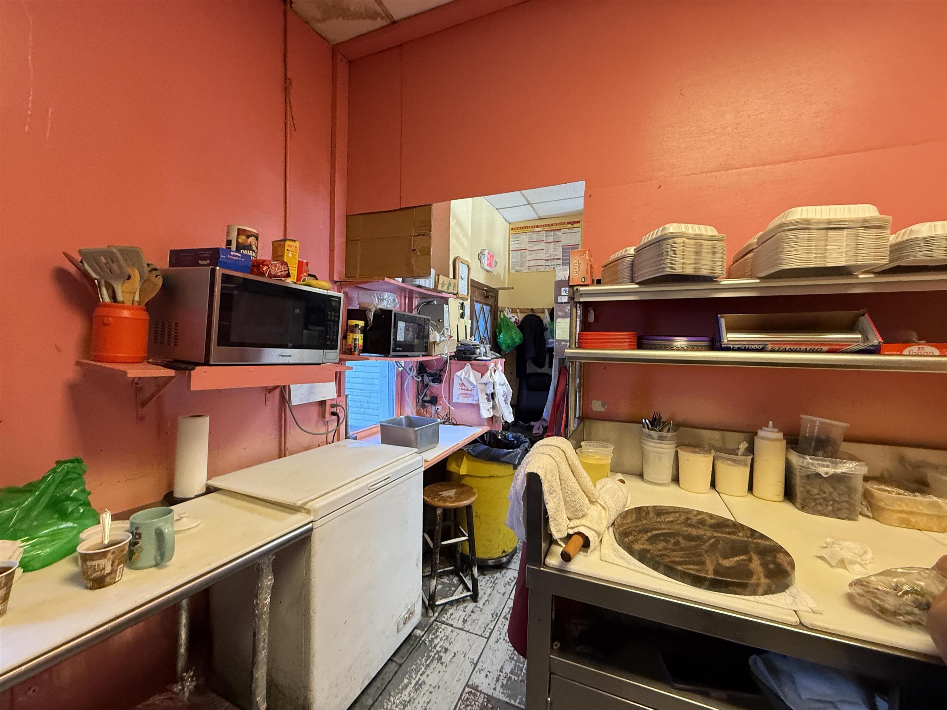 1309 Summit Avenue Union City, NJ 07087 - Photo 8 of 31 a view of a kitchen with a stove and a microwave