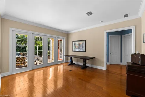 a view of a a dining room with furniture window and wooden floor