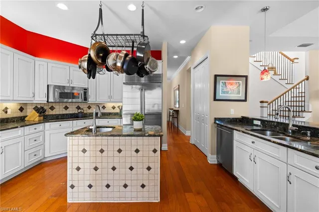 a kitchen with stainless steel appliances granite countertop a sink and a stove