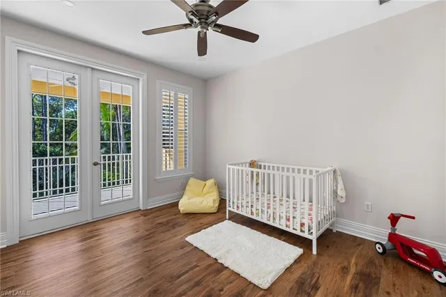 a view of a hallway with wooden floor and a kitchen