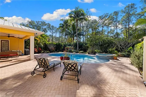 a view of a house with swimming pool and sitting area