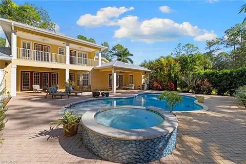 a swimming pool with outdoor seating and yard