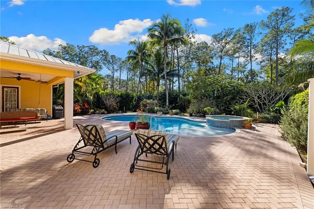 a view of a house with swimming pool and sitting area