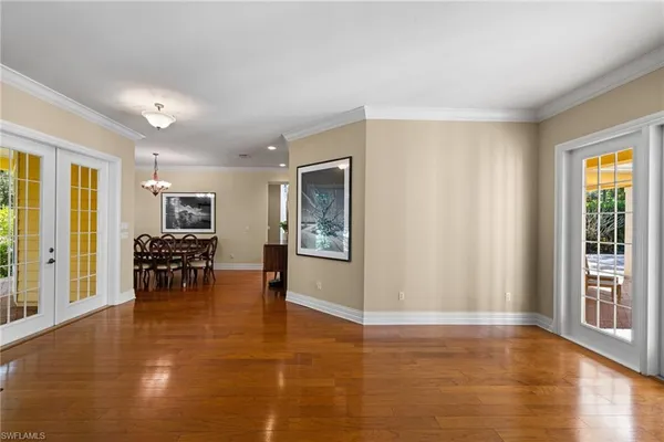 a living room with furniture and a table with wooden floor