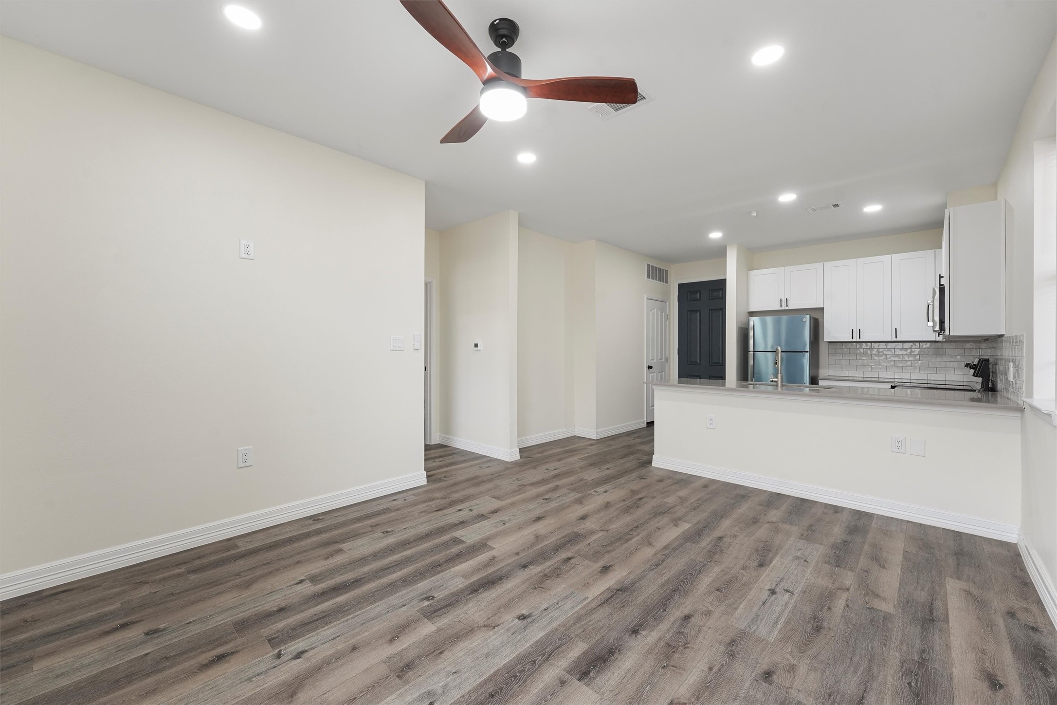 2130 Aldine Mail Rte Road, Unit A101 Houston, TX 77039 - Photo 3 of 9 a view of kitchen with wooden floor and a ceiling fan