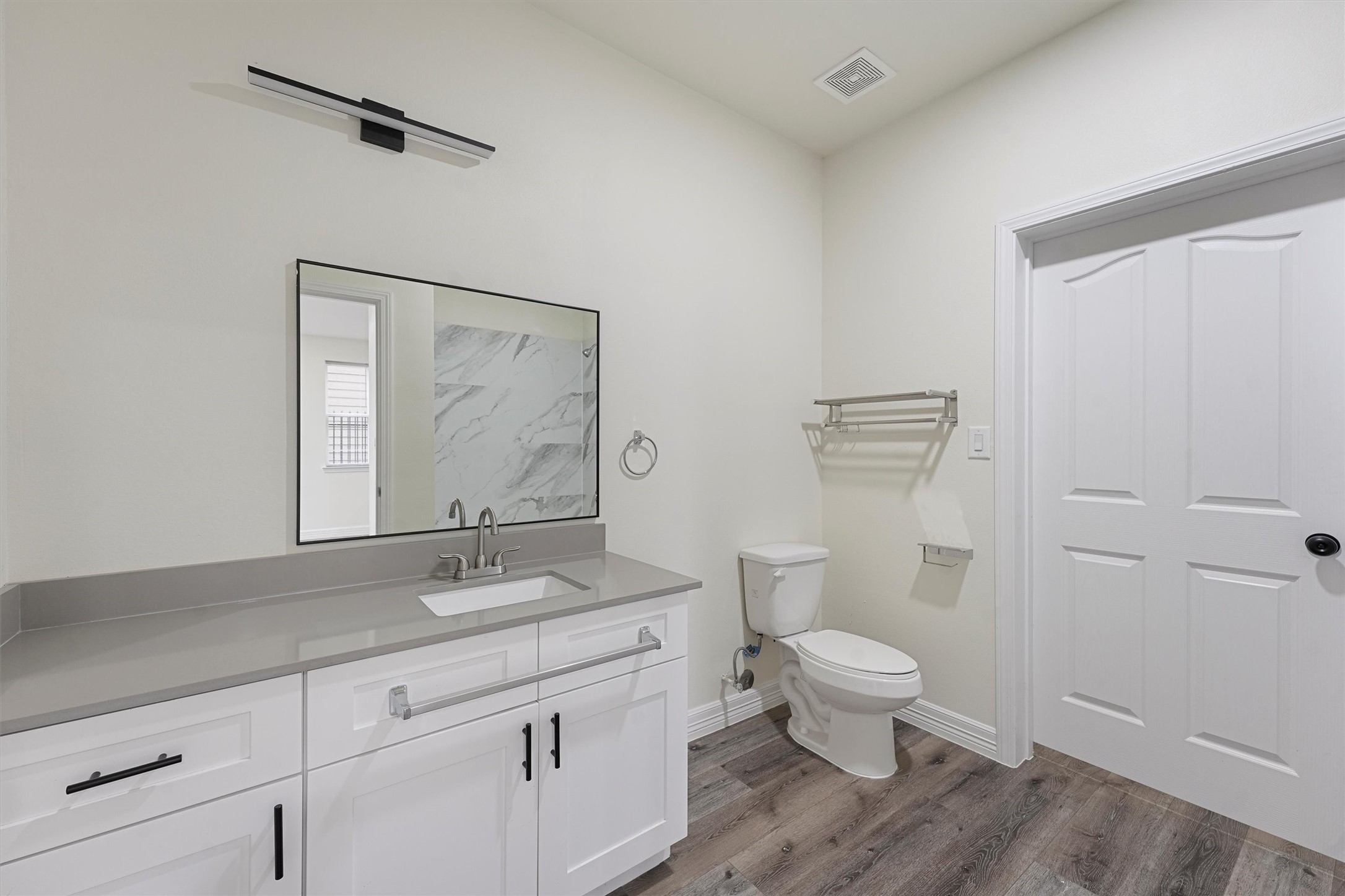 2130 Aldine Mail Rte Road, Unit A101 Houston, TX 77039 - Photo 4 of 9 a bathroom with a granite countertop sink a toilet and a mirror