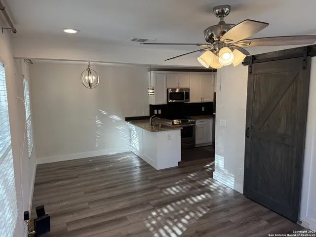 a kitchen with kitchen island a counter space a sink and appliances