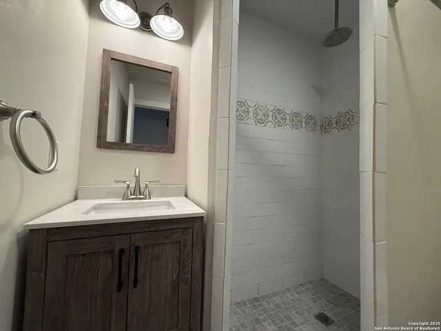 a bathroom with a sink a toilet and a mirror