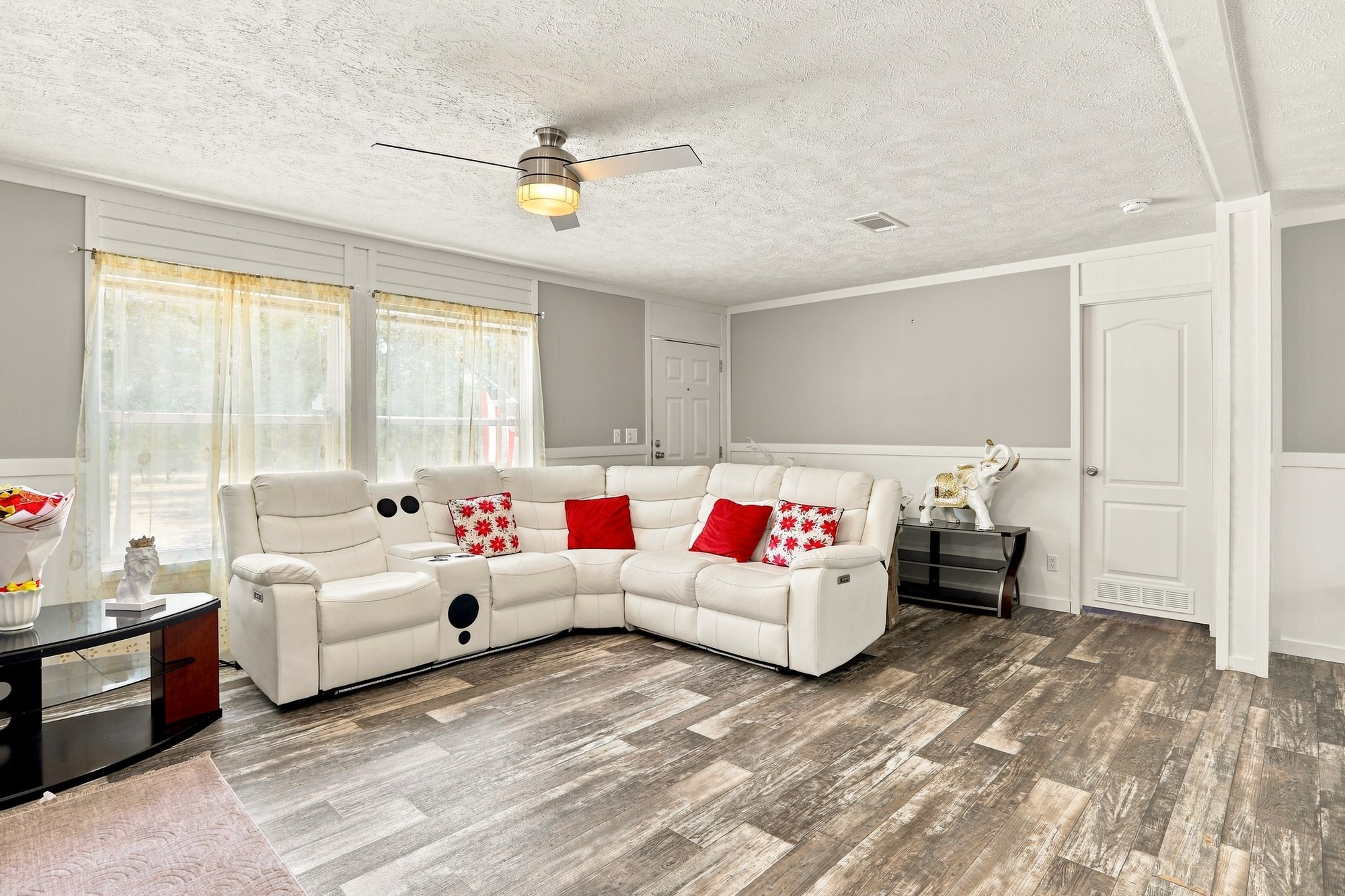 1039 Trailside Elgin, TX 78621 - Photo 5 of 24 Gleaming wood-look floors anchor a spacious living area illuminated by tall, bright windows.