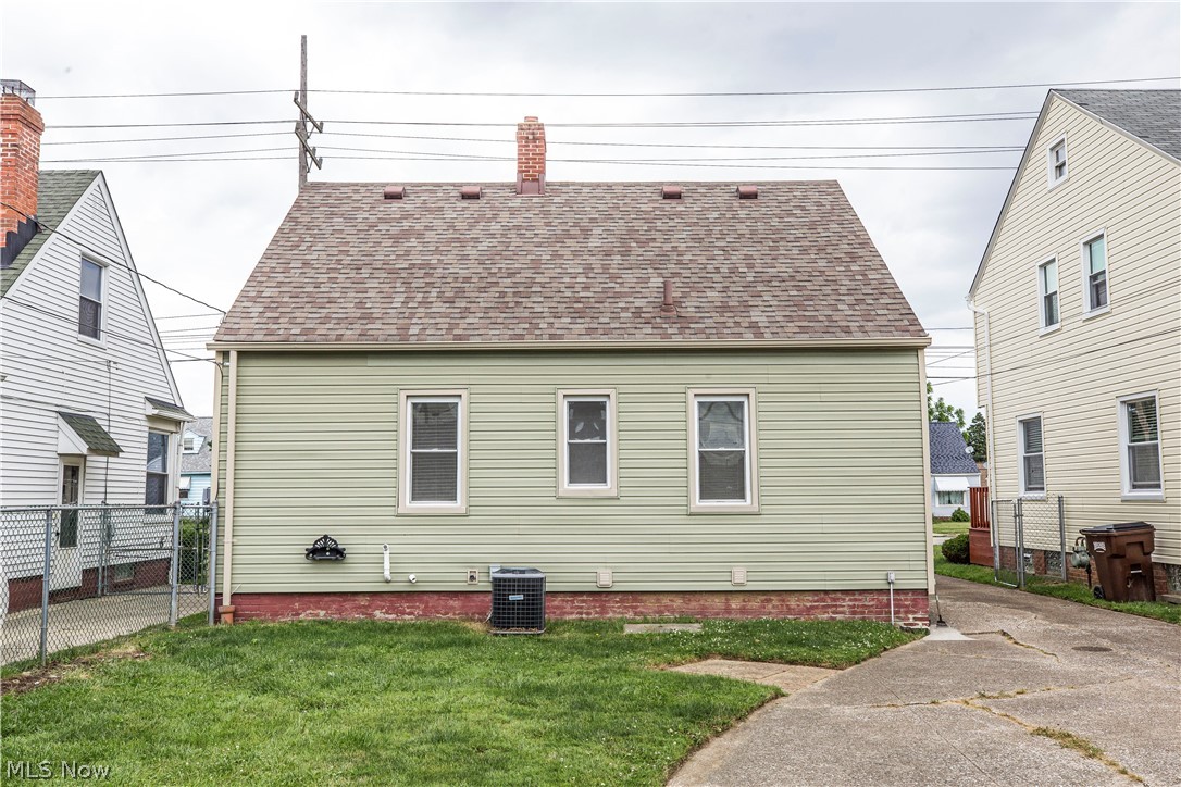 6203 Snow Road Parma, OH 44129 - Photo 25 of 29 Rear view of house with a lawn and central air condition unit