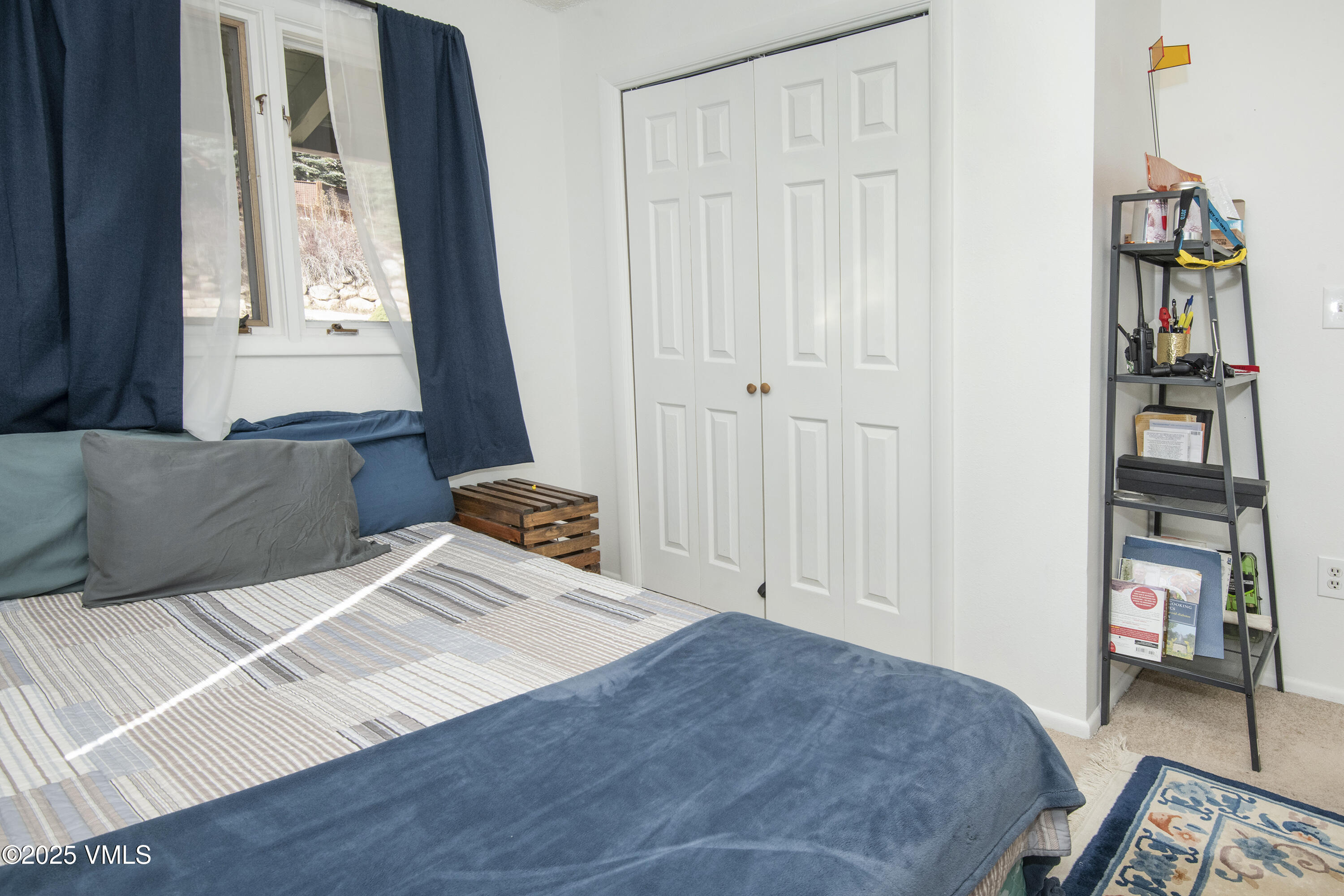 2448 Garmisch Drive, Unit 4 Vail, CO 81657 - Photo 11 of 19 a bedroom with a bed and a window