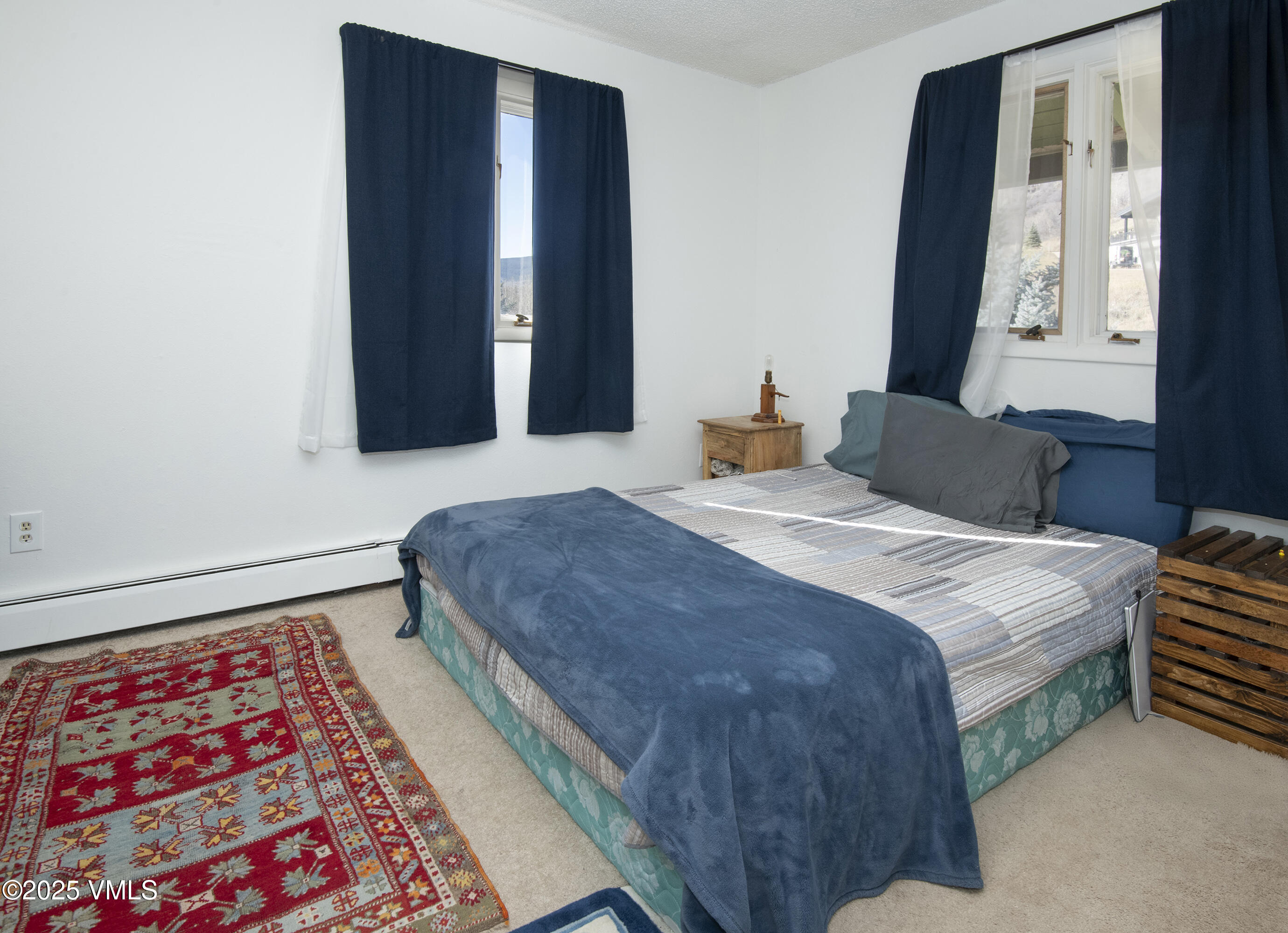 2448 Garmisch Drive, Unit 4 Vail, CO 81657 - Photo 12 of 19 a bedroom with a bed and a window