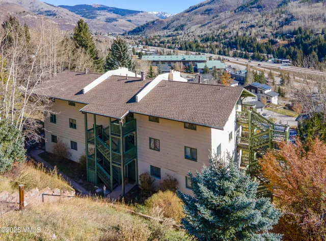 a view of house with large windows and a tree