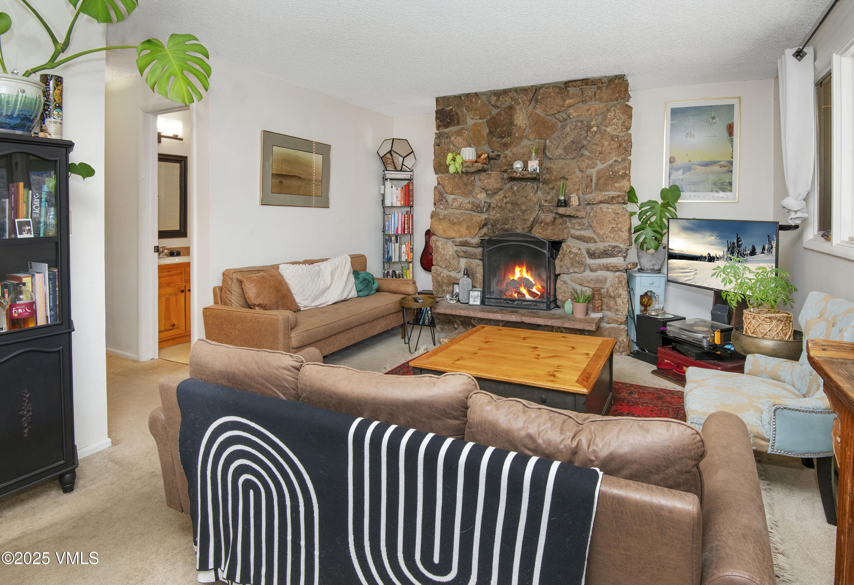 2448 Garmisch Drive, Unit 4 Vail, CO 81657 - Photo 3 of 19 a living room with furniture a flat screen tv and a fireplace