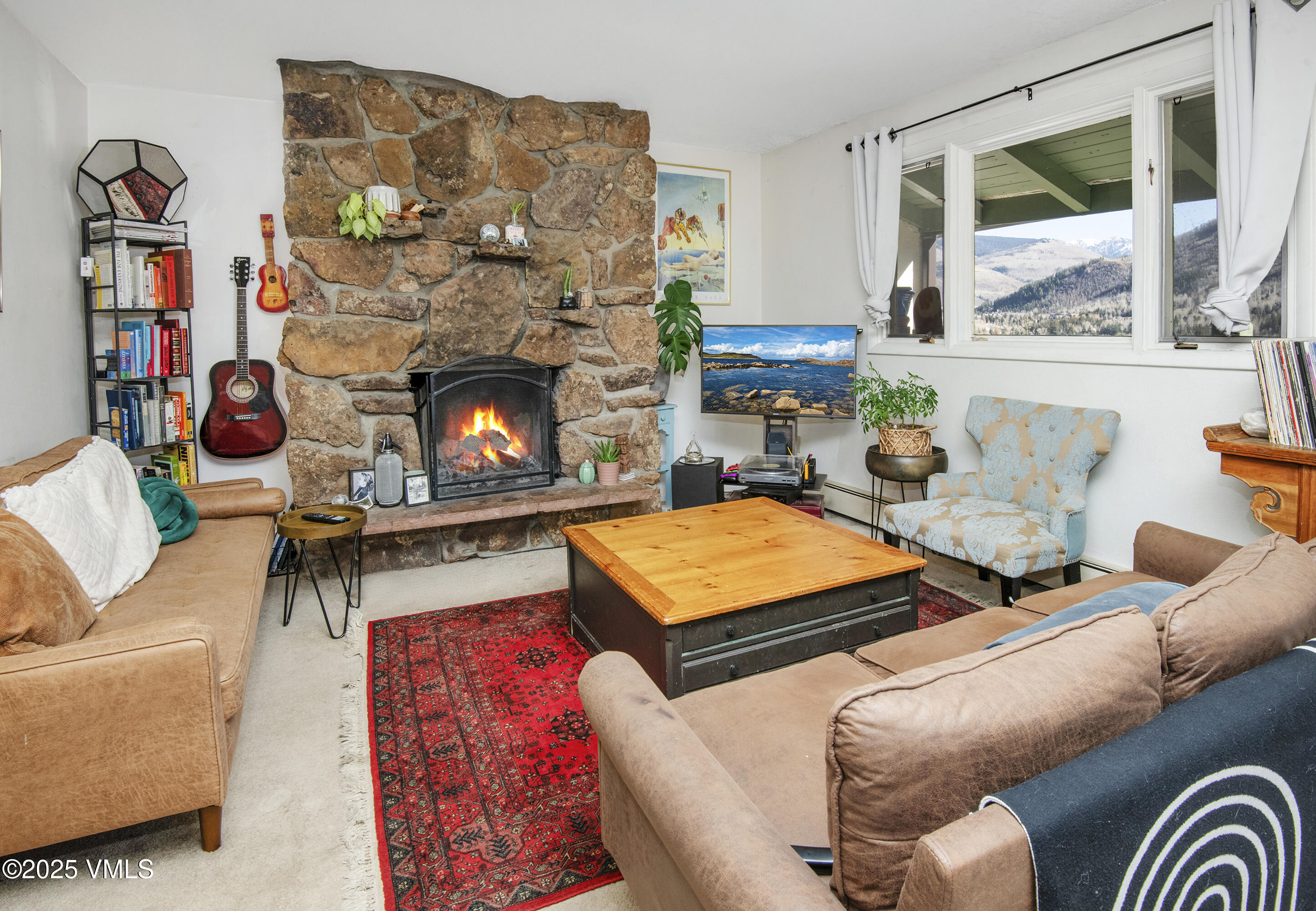 2448 Garmisch Drive, Unit 4 Vail, CO 81657 - Photo 4 of 19 a living room with furniture a flat screen tv and a fireplace