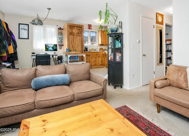a kitchen with stainless steel appliances kitchen island granite countertop a table chairs and a refrigerator