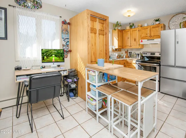 a kitchen with stainless steel appliances a stove a sink and a refrigerator