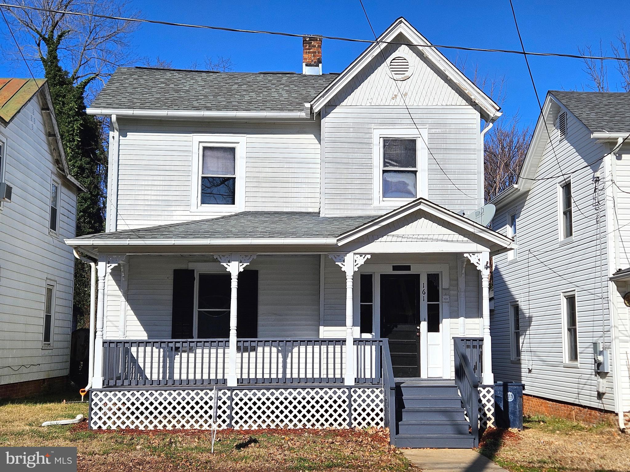 161 East Main Street Orange, VA 22960 - Photo 1 of 19 a view of a house with a small yard and wooden fence