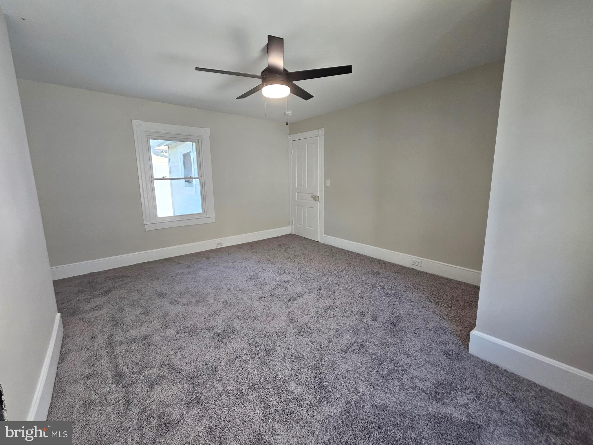 161 East Main Street Orange, VA 22960 - Photo 16 of 19 an empty room with a ceiling fan and window
