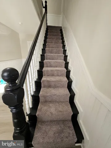 a bathroom with a sink a toilet a mirror and shower