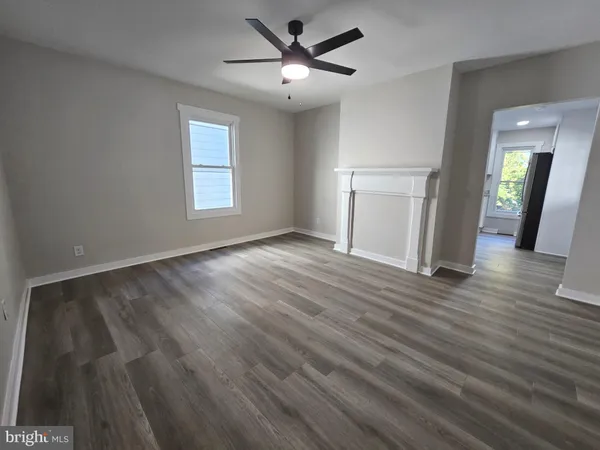 a kitchen with granite countertop a stove top oven a sink dishwasher and a microwave oven on the wooden floor