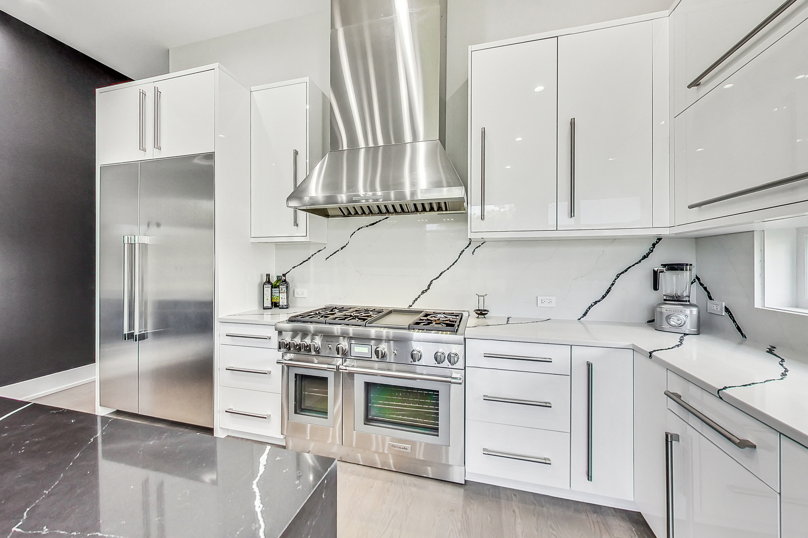 1331 Pfingsten Road Northbrook, IL 60062 - Photo 14 of 38 a kitchen with granite countertop a stove a sink and white cabinets