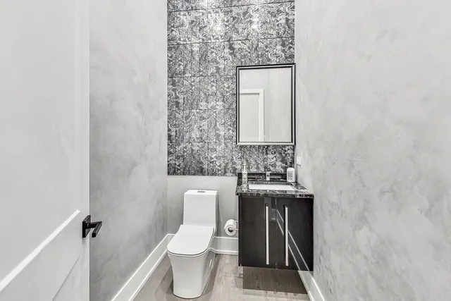 a bathroom with a toilet sink and mirror
