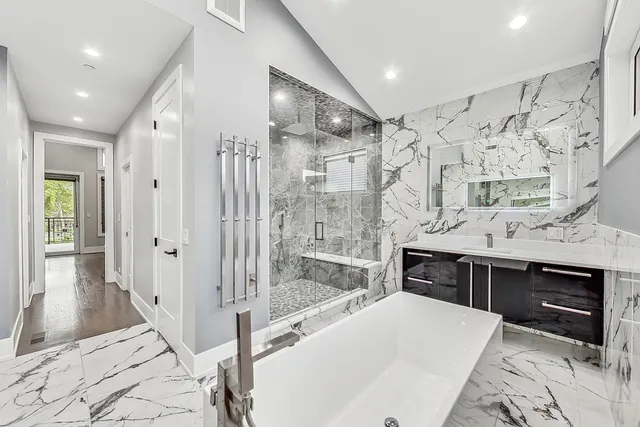 a spacious bathroom with a bathtub and a shower