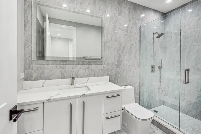 a bathroom with a sink toilet and shower