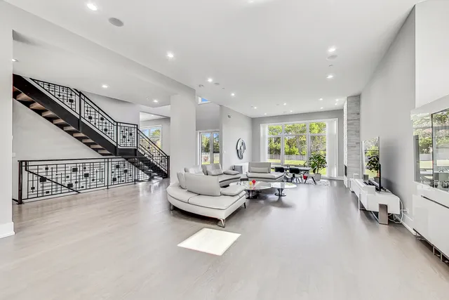 a living room with furniture and hard wood floor