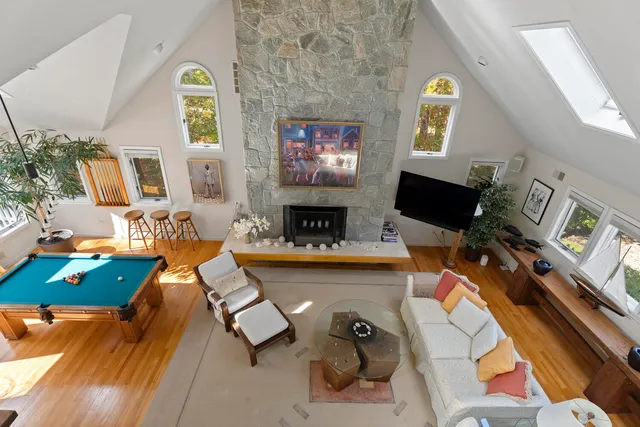 a living room with furniture and large windows